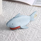 Light blue shark-shaped key cover with red zipper and gold key ring