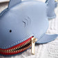 Light blue shark key cover close-up with red zipper and gold zipper pull