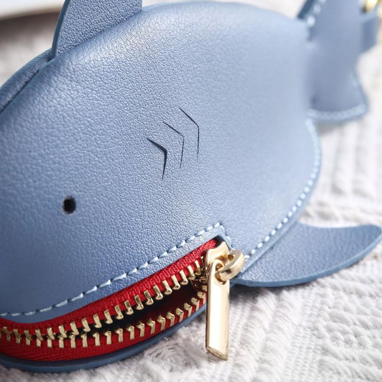 Light blue shark key cover close-up with red zipper and gold zipper pull