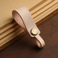 Light tan leather lanyard keychain with round brass snap and finger-loop end.