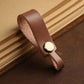 Brown leather lanyard keychain with round brass snap and finger-loop end.