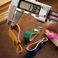 Brown leather lanyard keychain with metal snap and loop, measured with caliper.