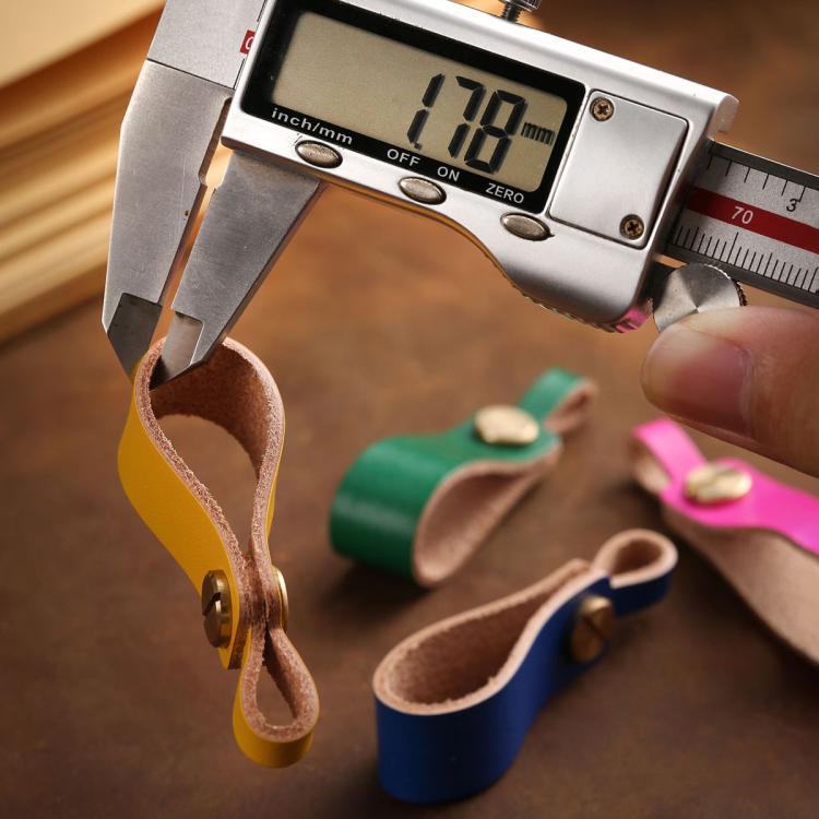 Brown leather lanyard keychain with metal snap and loop, measured with caliper.