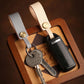 Leather lanyard keychain with brass snap holding keys and a car remote in box.