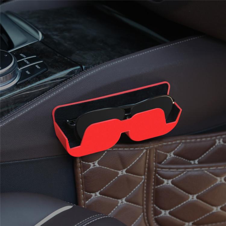 Adhesive car glasses case in red, holding sunglasses on a dashboard