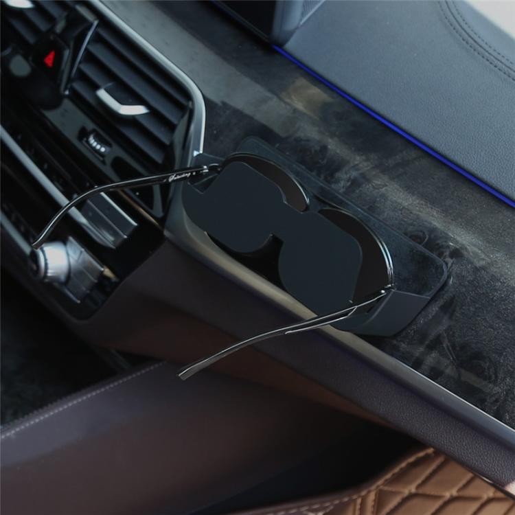 Adhesive car glasses case in black, attached near the center console