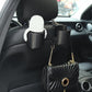 Car seat cup holder with hanging loop, black holder holding a white wipe container