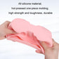 Pink silicone cup holder insert held in hand, showing dual circular wells and tray