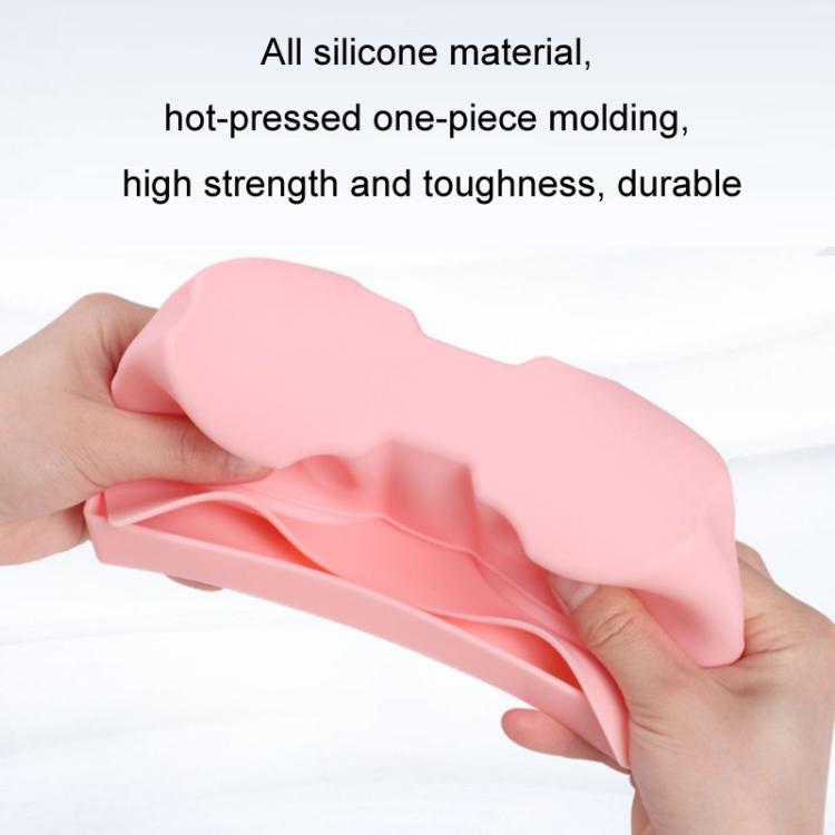 Pink silicone cup holder insert held in hand, showing dual circular wells and tray