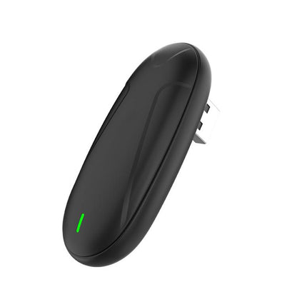 Black oval wireless CarPlay adapter with green status light and side connector pins