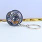 Wheel hub brake keychain with black rim and yellow brake caliper, silver chain key ring