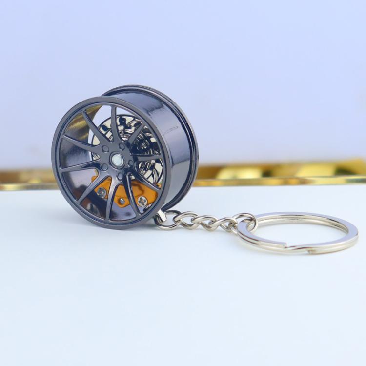 Wheel hub brake keychain with black rim and yellow brake caliper, silver chain key ring