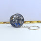 Wheel hub brake keychain with black rim and blue brake caliper, silver chain key ring
