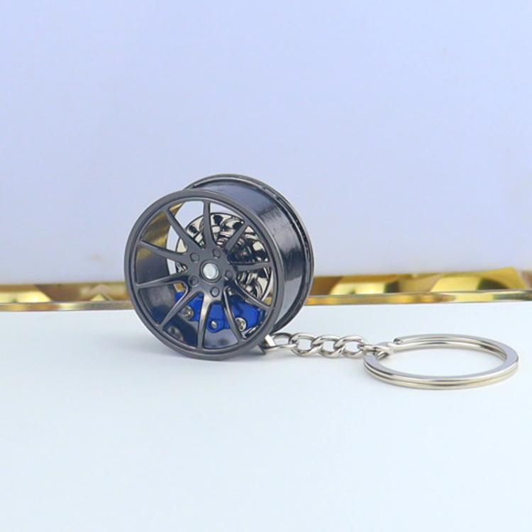 Wheel hub brake keychain with black rim and blue brake caliper, silver chain key ring
