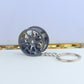 Wheel hub brake keychain with black rim and blue brake caliper, extended key ring