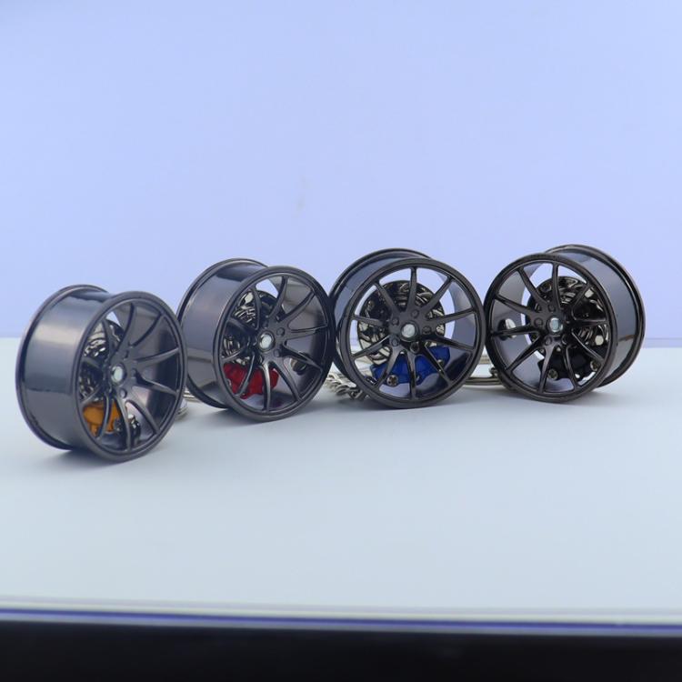 Set of metal wheel hub brake keychains with four wheel designs and colored calipers
