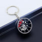 Wheel hub brake keychain with black rim and red brake caliper, silver key ring on car door