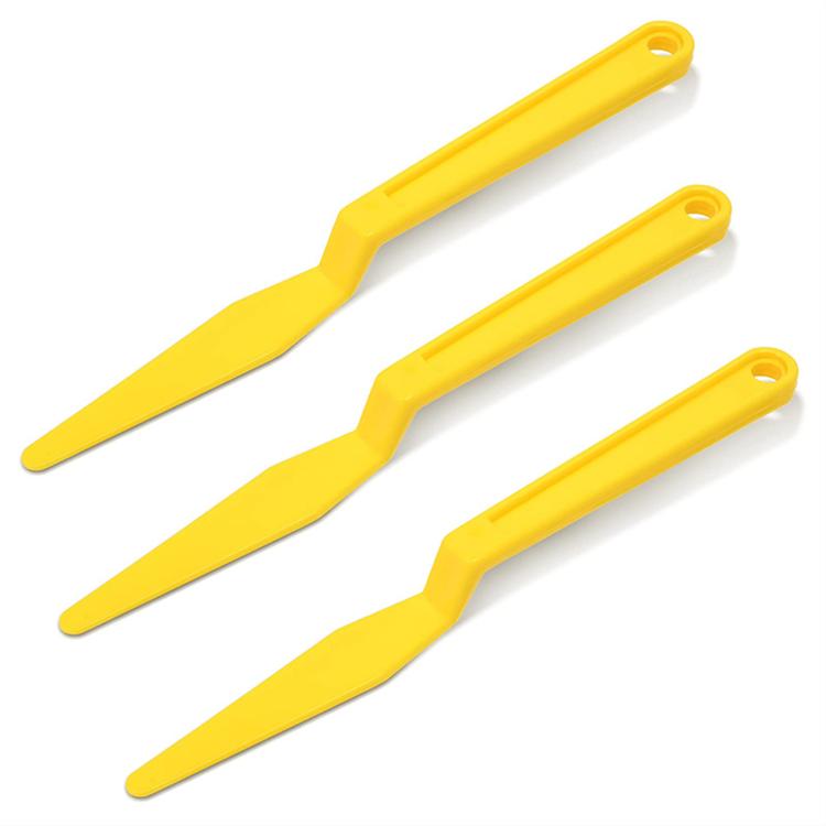 Set of three yellow plastic film scraper and seam tape handling tools
