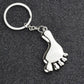 Silver metal foot-shaped keychain charm with chain and loop keyring