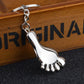 Silver metal foot-shaped keychain charm with chain and keyring