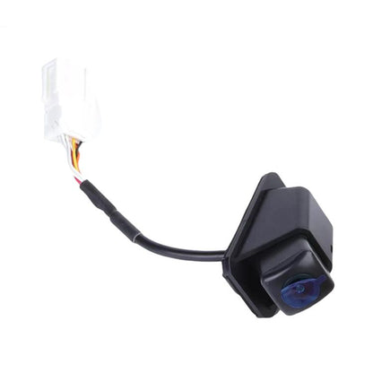 Rear view backup camera module with attached wiring harness and blue lens