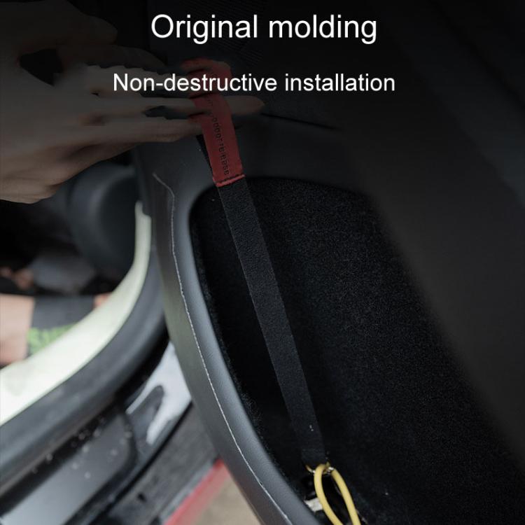 Red manual release pull cord installed on black door panel trim