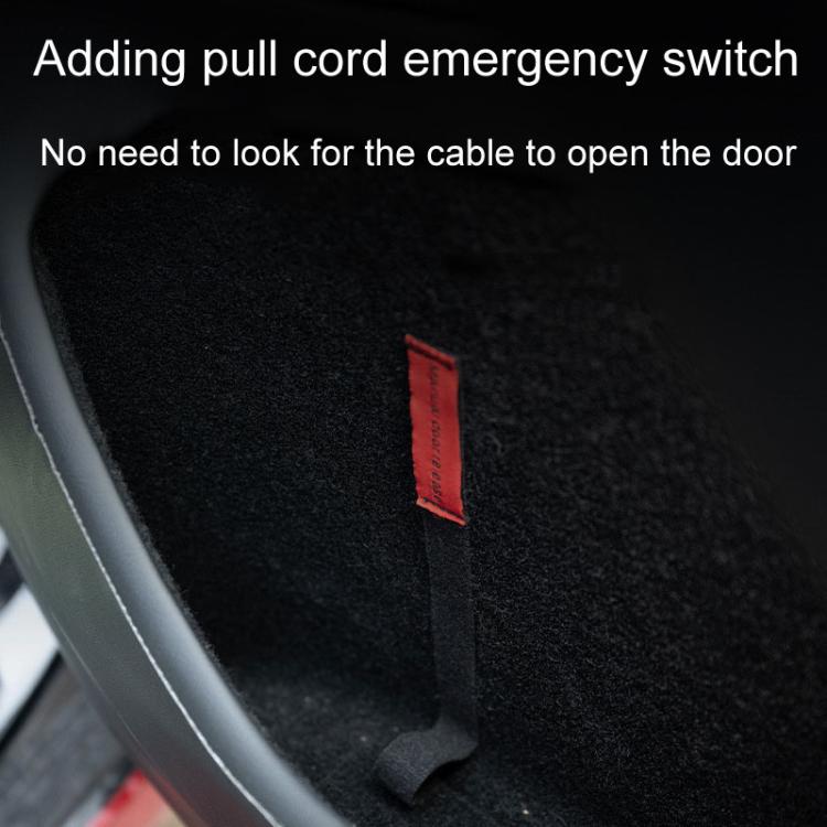 Red emergency pull cord tab on black interior door panel