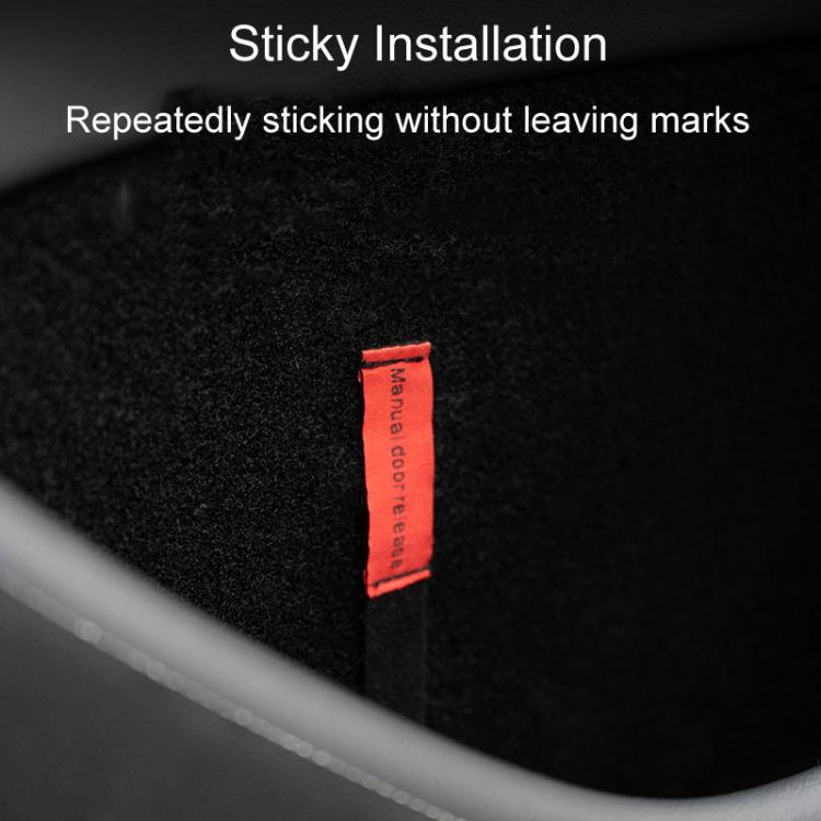 Red manual door release tab on black emergency pull cord panel strip