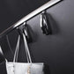 Black glossy concealed glove box hooks mounted on dashboard panel with hanging straps