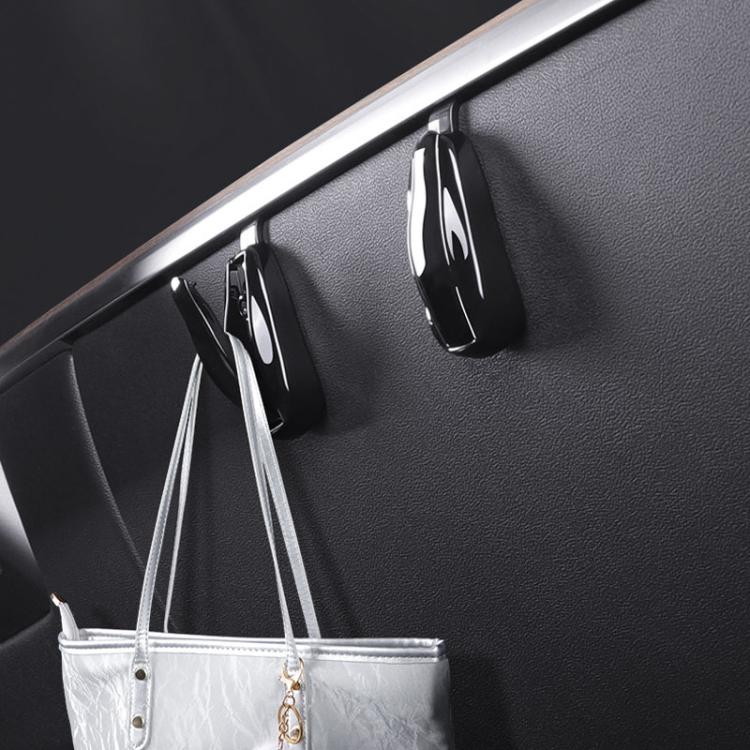 Black glossy concealed glove box hooks mounted on dashboard panel with hanging straps