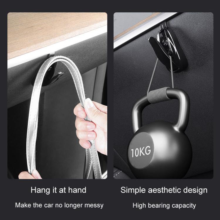 Black concealed glove box hook securing a hanging strap and holding a kettle-style weight