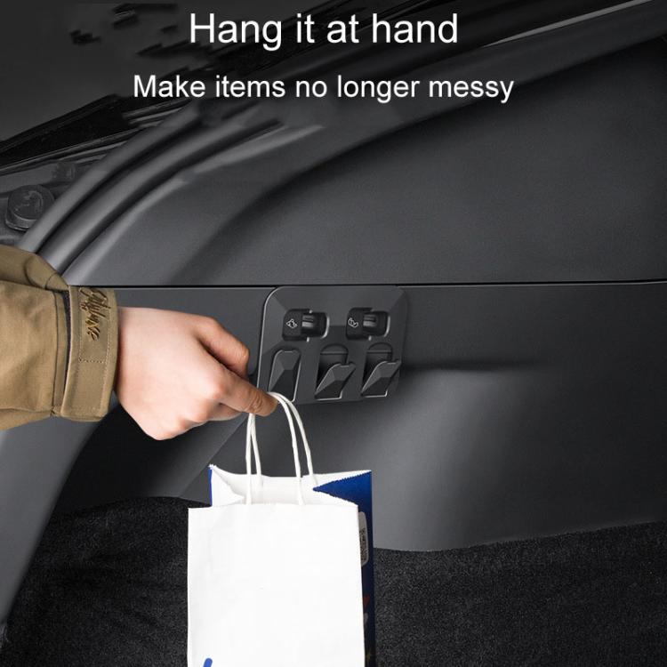 Trunk folding hooks for hanging shopping bags, dark gray panel with accessible hang points