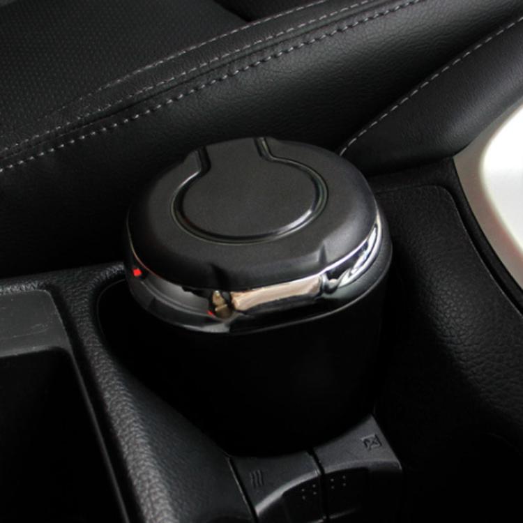 Black car cigarette ashtray seated in cupholder with glowing lid light