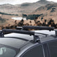 Black surfboard roof rack padding on roof crossbars for secure board transport