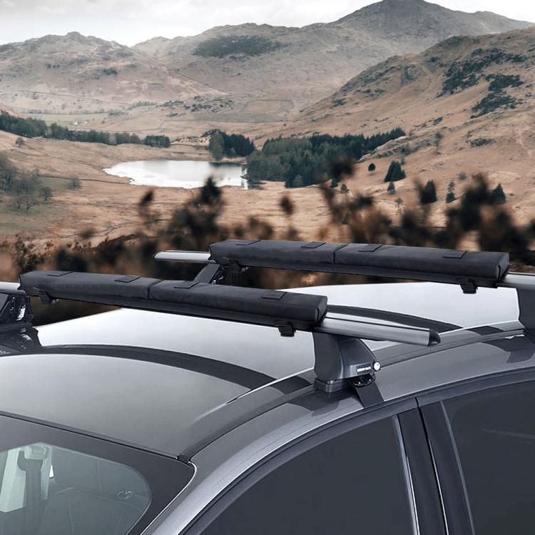 Black surfboard roof rack padding on roof crossbars for secure board transport