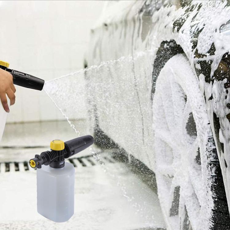 Foam sprayer spraying thick white suds onto a car door and wheel