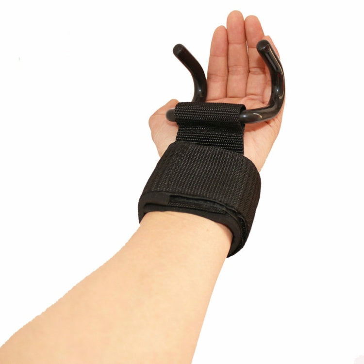 Black pull-up booster belt held in hand, showing metal hooks and woven strap pad