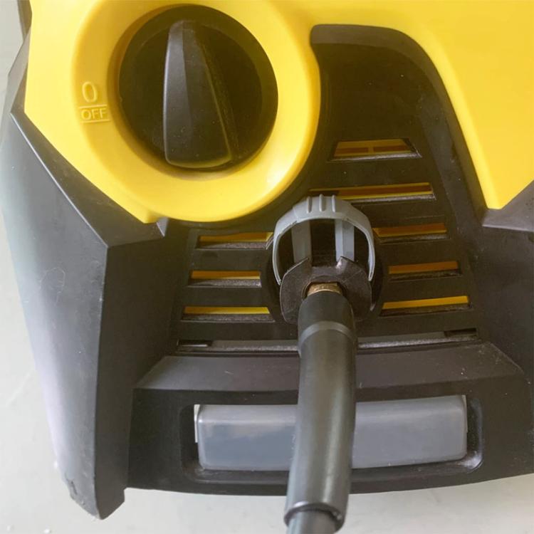 Quick coupling clamp attached to pressure washer outlet with gray hose