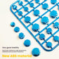 Blue decorative hex screw caps scattered beside a mounting tray