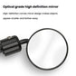 Close-up of round convex rearview mirror with black stem and clear lens surface