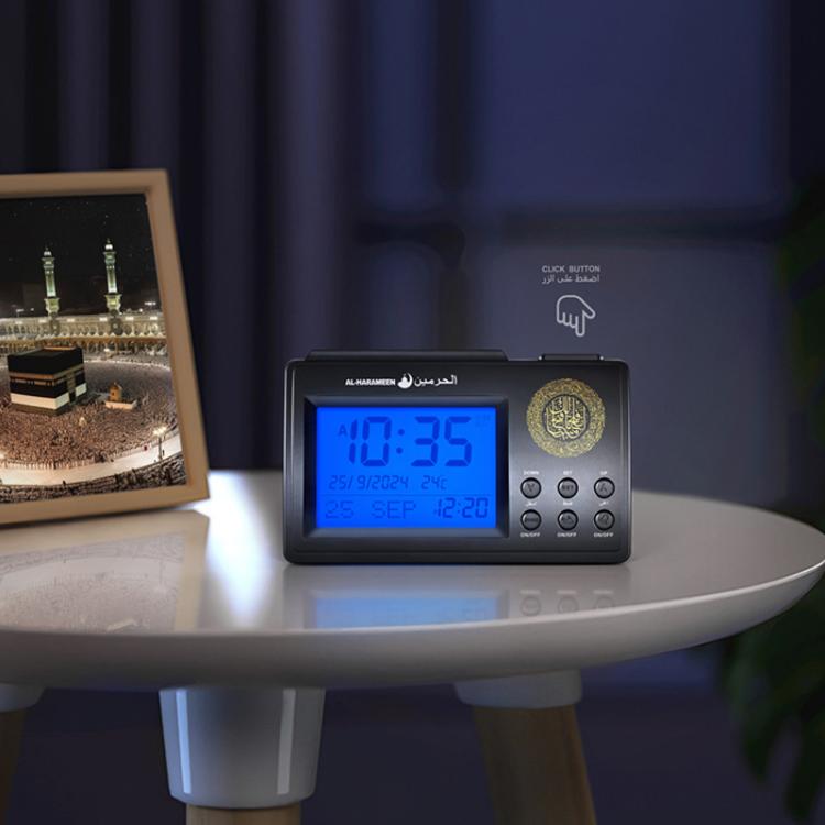 Black AL-HARAMEEN digital desk clock on tabletop with illuminated display