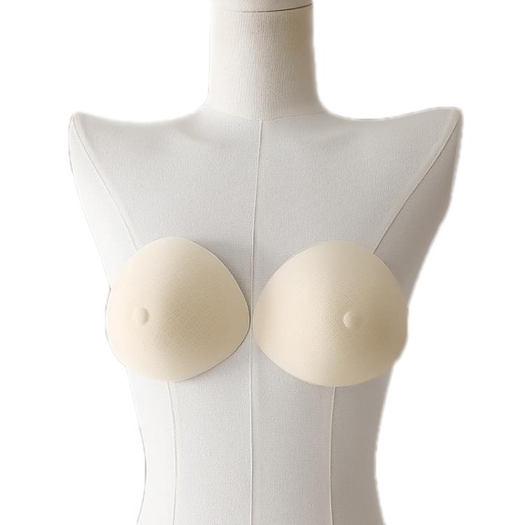 Non-adhesive post-mastectomy bra with two beige prosthetic breast pads on mannequin