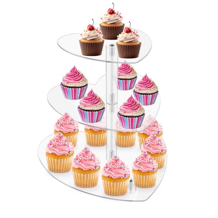 Three-tier heart-shaped acrylic cupcake stand displaying pink frosted cupcakes