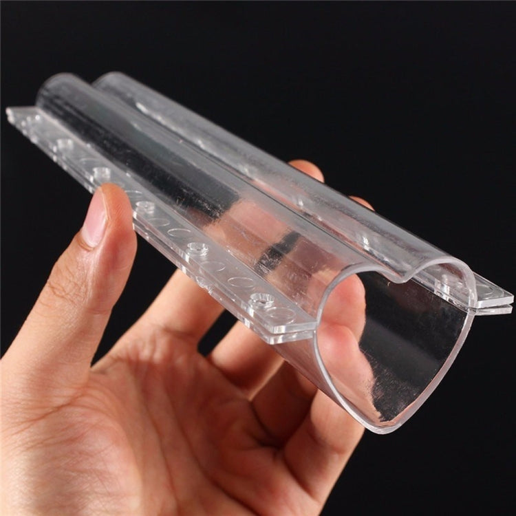 Transparent heart-shaped plastic mold for fruit shaping, shown in hand