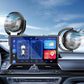 Car dashboard with two corner fans flanking the touchscreen, black grille airflow
