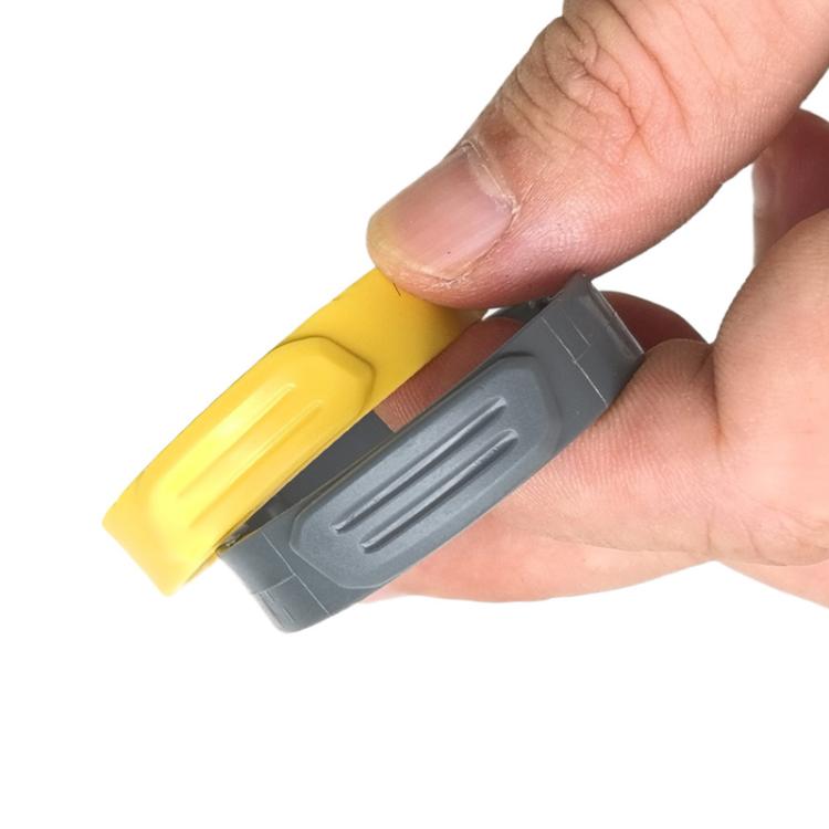 Hand holding yellow and gray ring handle parts for vacuum hose