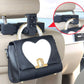Car seatback hanging hook with suction cup mount holding a handbag
