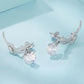 Dachshund charm earrings angled view with round clear stones, silver-tone