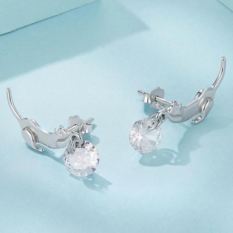Dachshund charm earrings angled view with round clear stones, silver-tone