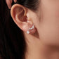 Dachshund charm earrings on ear, silver-tone with round crystal drop